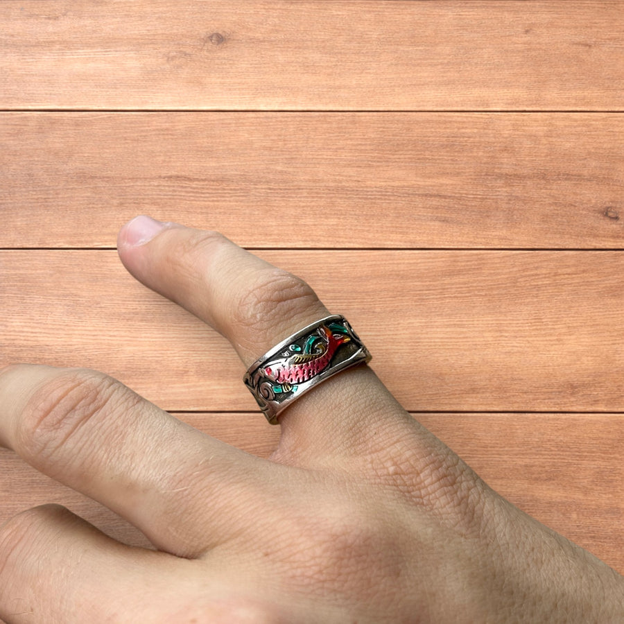 Vintage style adjustable silver stainless steel ring with multicoloured retro fish design worn on finger