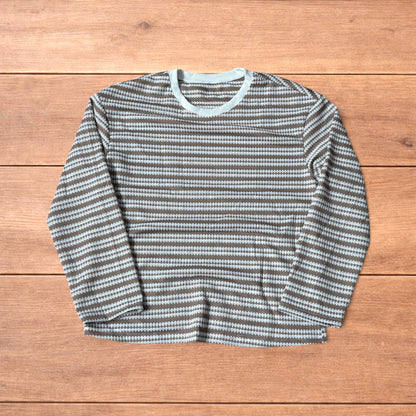 Relaxed fit striped knit top t-shirt in brown and cream laid flat on wooden floor.
