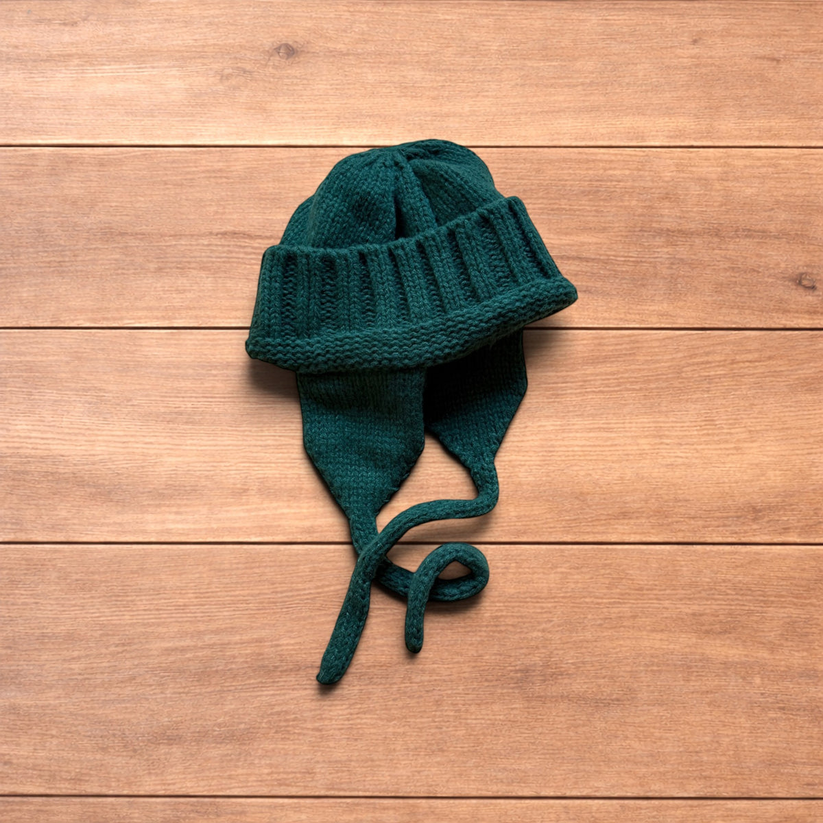 Vintage style dappy ear flap bobble hat in dark green.