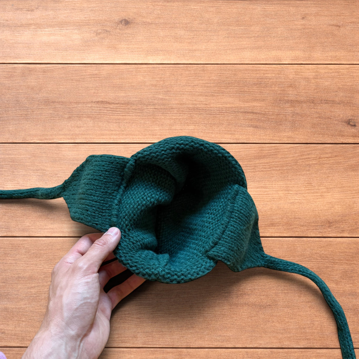 Vintage style dappy ear flap bobble hat in dark green.