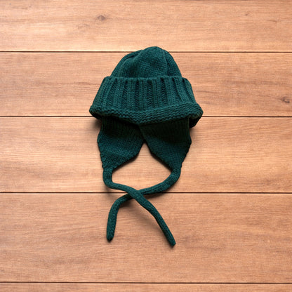 Vintage style dappy ear flap bobble hat in dark green.