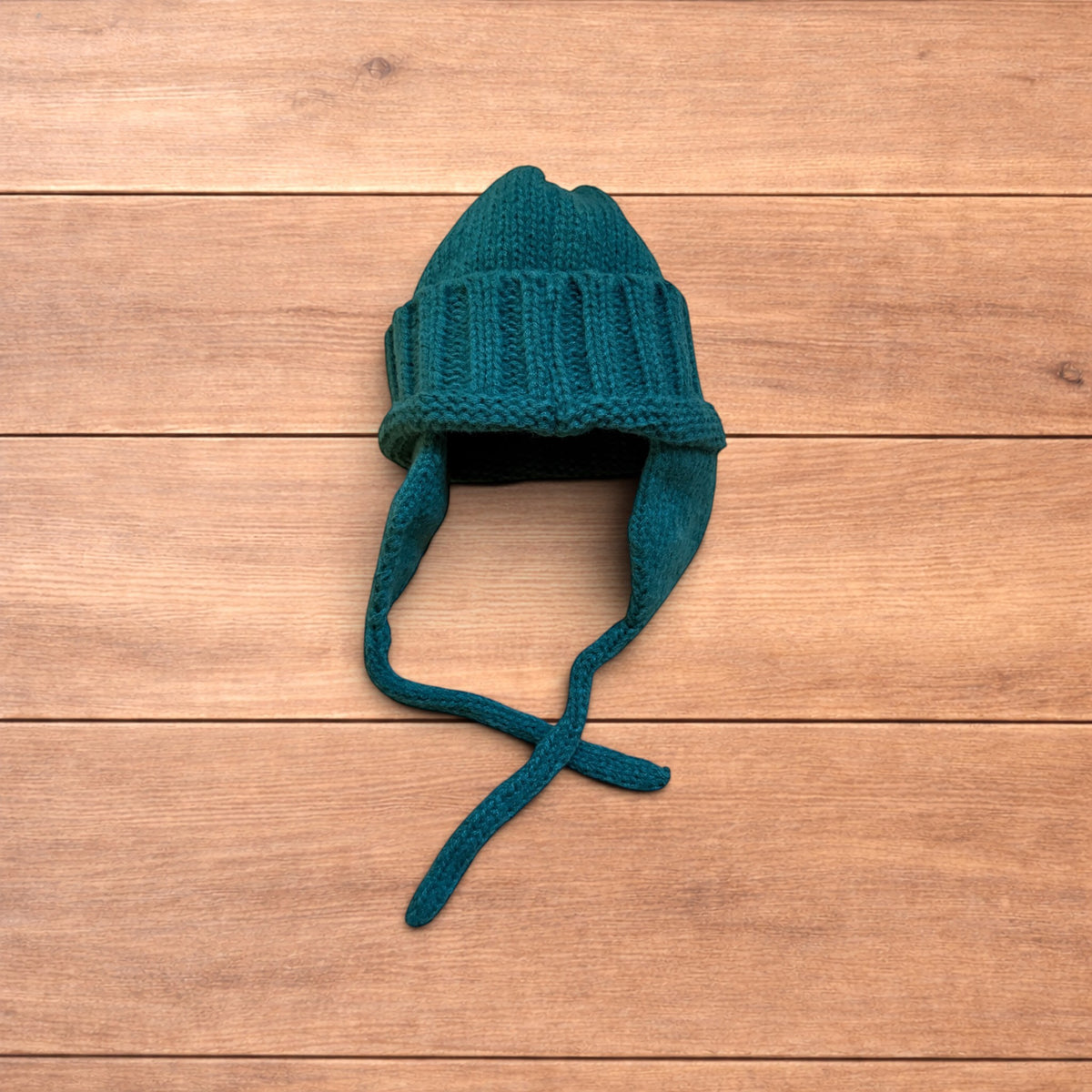 Vintage style dappy ear flap bobble hat in dark green.