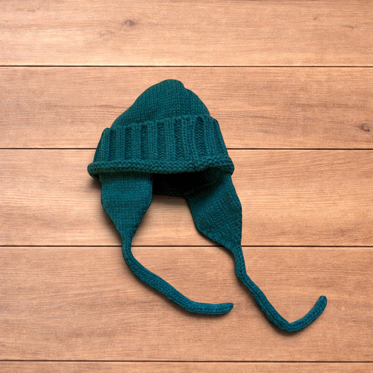 Vintage style dappy ear flap bobble hat in dark green.