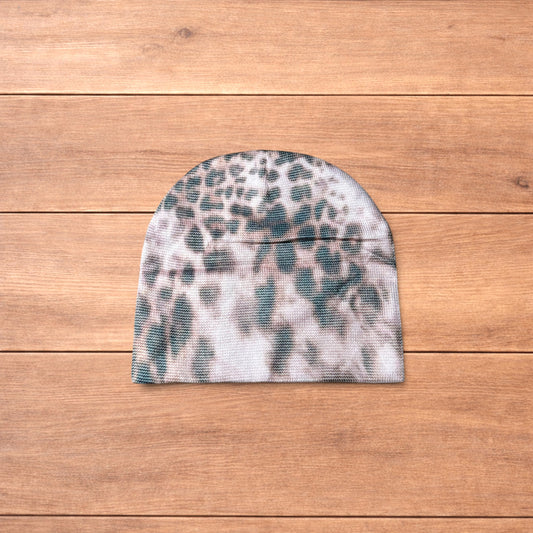 Japanese vintage style beige beanie hat with beige animal print pattern laid flat on wooden surface.