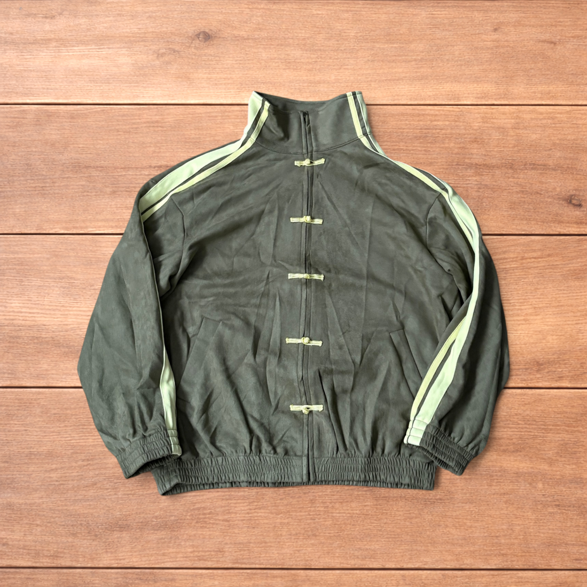 Japanese style zip up track jacket in khaki green with pale green stripes on sleeves and knotted loop front fastenings.