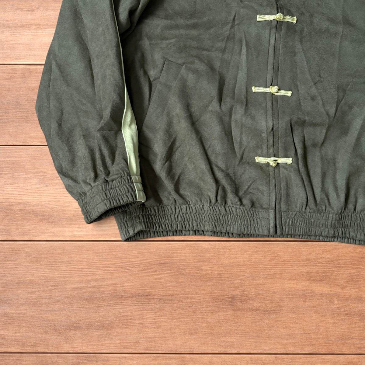 Japanese style zip up track jacket in khaki green with pale green stripes on sleeves and knotted loop front fastenings.