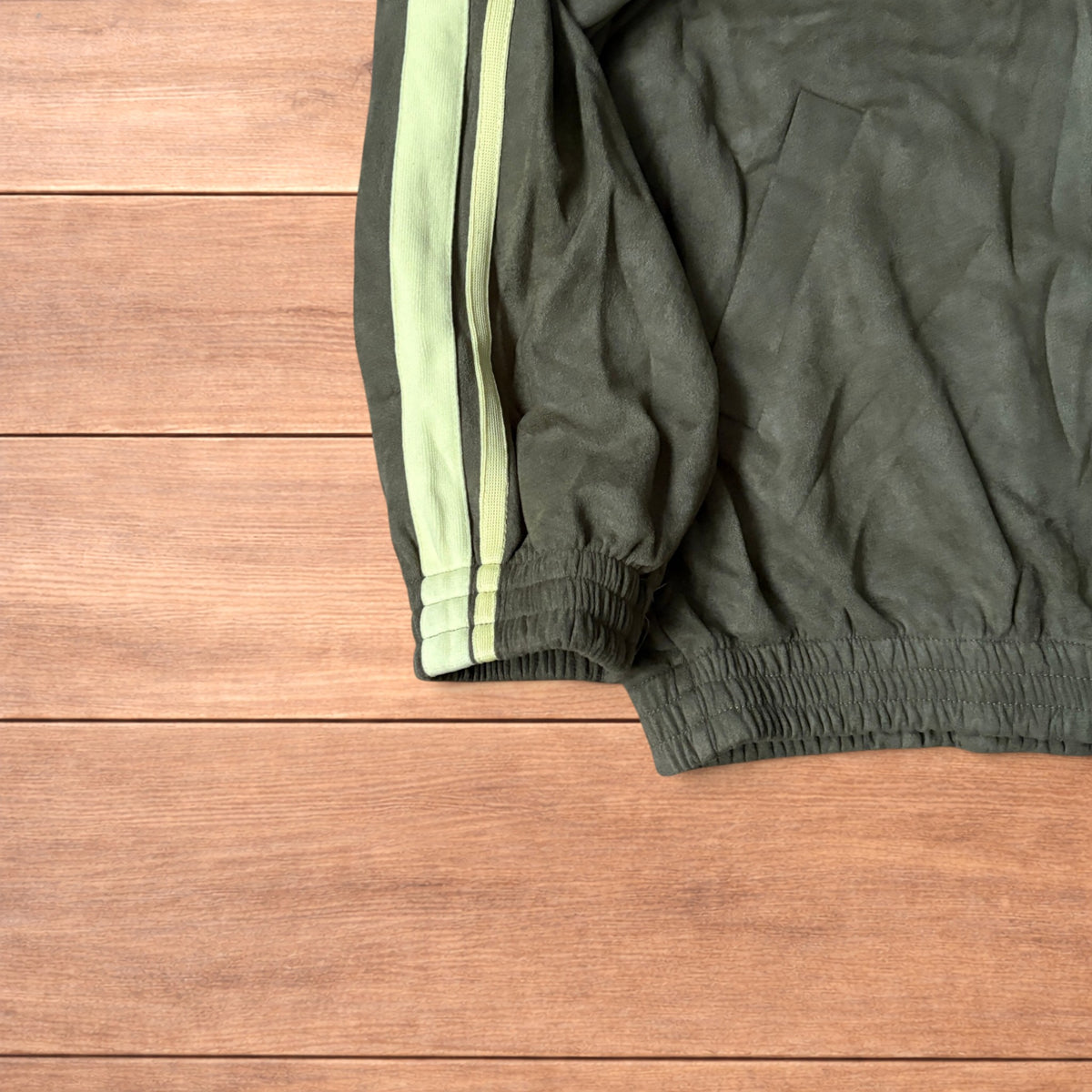 Japanese style zip up track jacket in khaki green with pale green stripes on sleeves and knotted loop front fastenings.