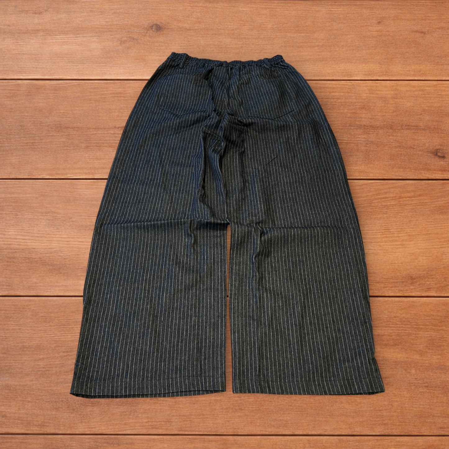 Vintage style baggy wide leg pleated twill pinstripe trousers in navy blue.