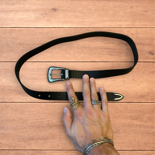 Vintage style faux leather western cowboy belt in black with silver trim.