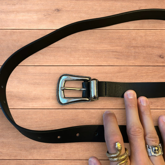 Vintage style faux leather western cowboy belt in black with silver trim.