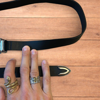 Vintage style faux leather western cowboy belt in black with silver trim.