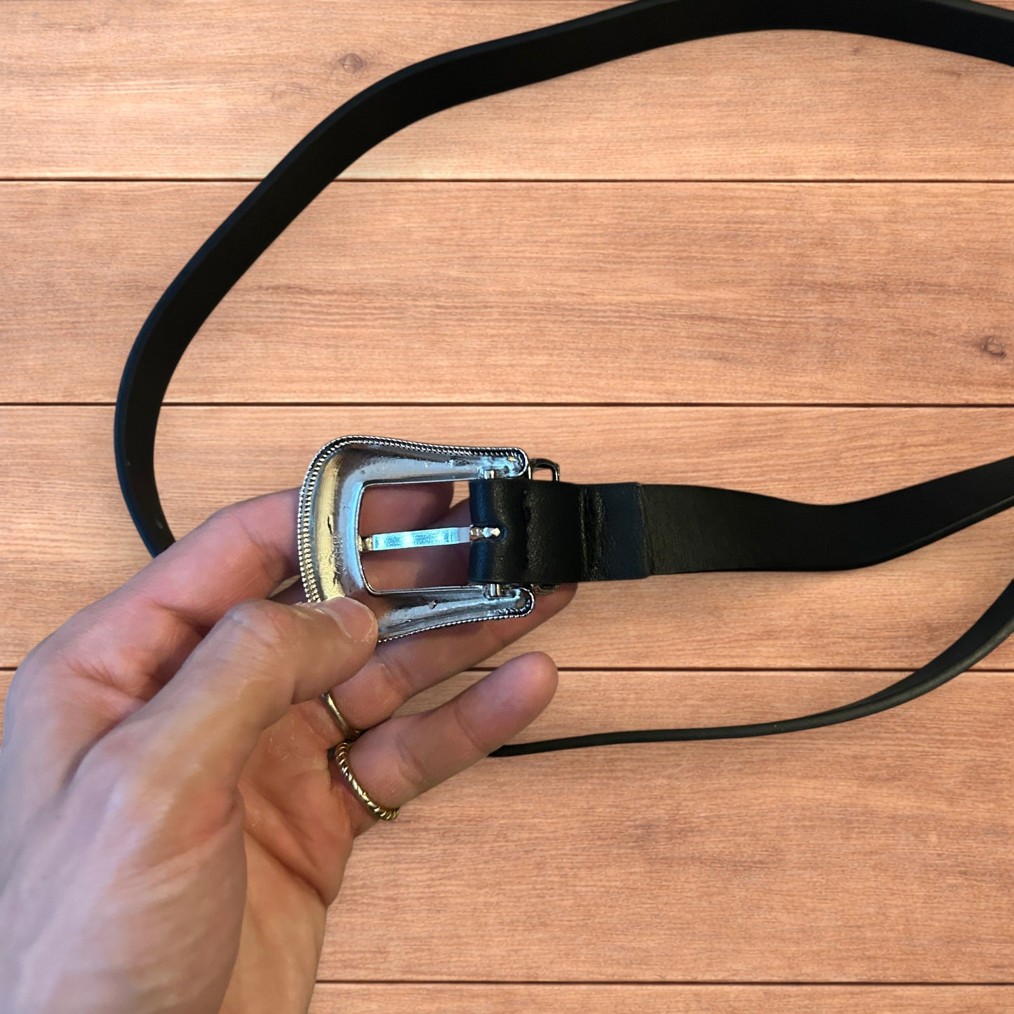 Vintage style faux leather western cowboy belt in black with silver trim.