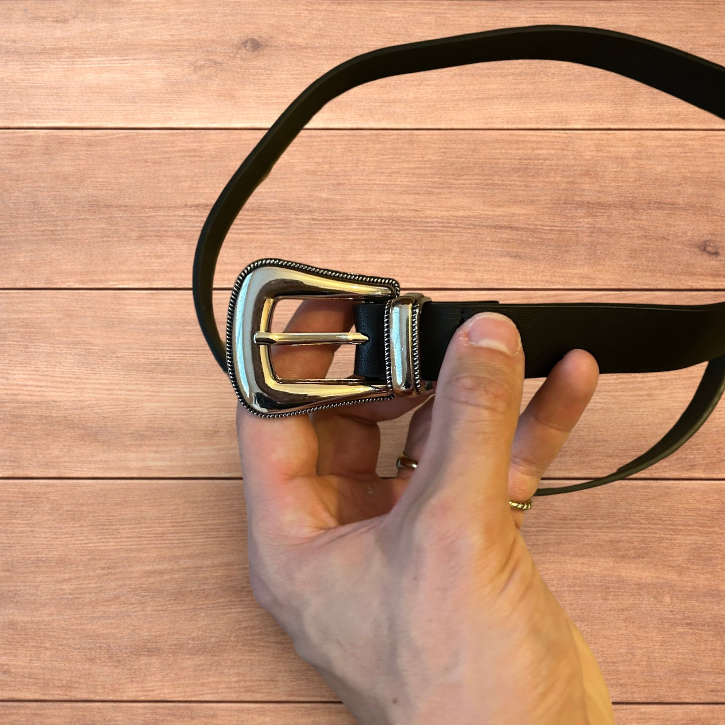 Vintage style faux leather western cowboy belt in black with silver trim.