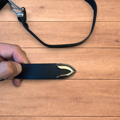 Vintage style faux leather western cowboy belt in black with silver trim.