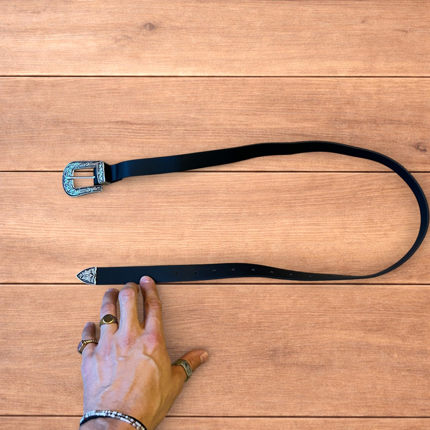 Vintage style faux leather western cowboy belt in black with silver trim.
