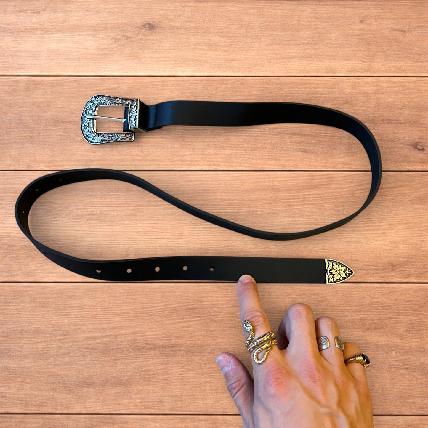 Vintage style faux leather western cowboy belt in black with silver trim.