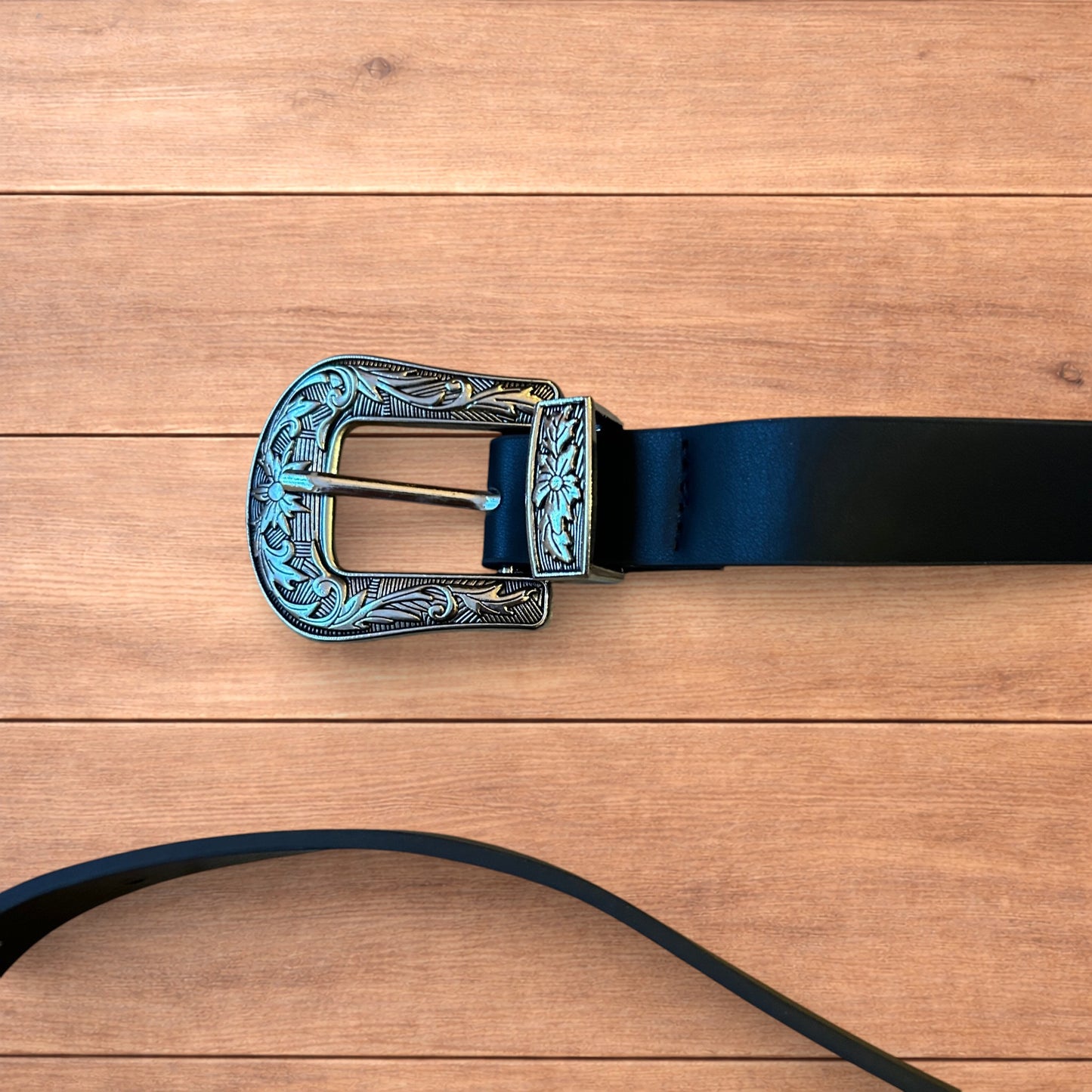 Vintage style faux leather western cowboy belt in black with silver trim.