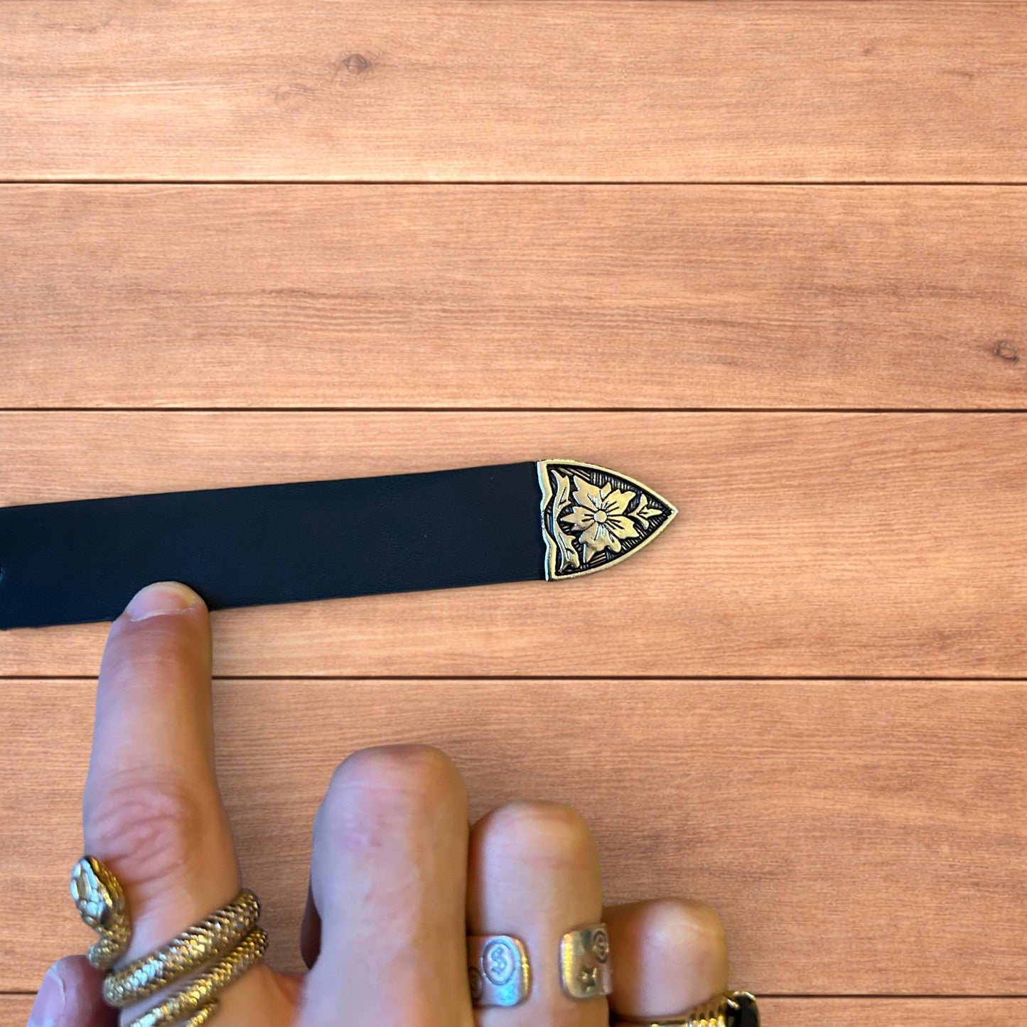 Vintage style faux leather western cowboy belt in black with silver trim.