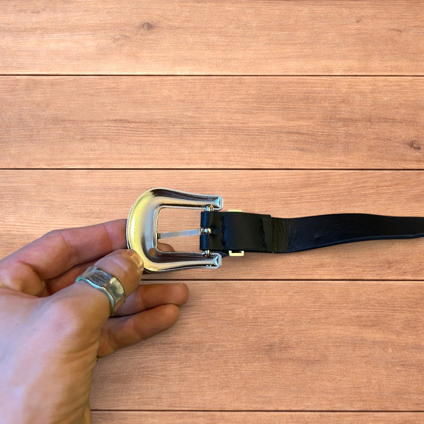 Vintage style faux leather western cowboy belt in black with silver trim.