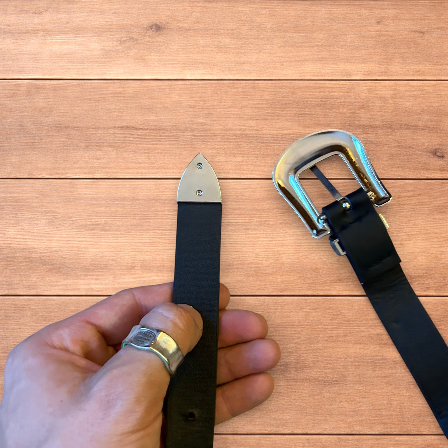 Vintage style faux leather western cowboy belt in black with silver trim.
