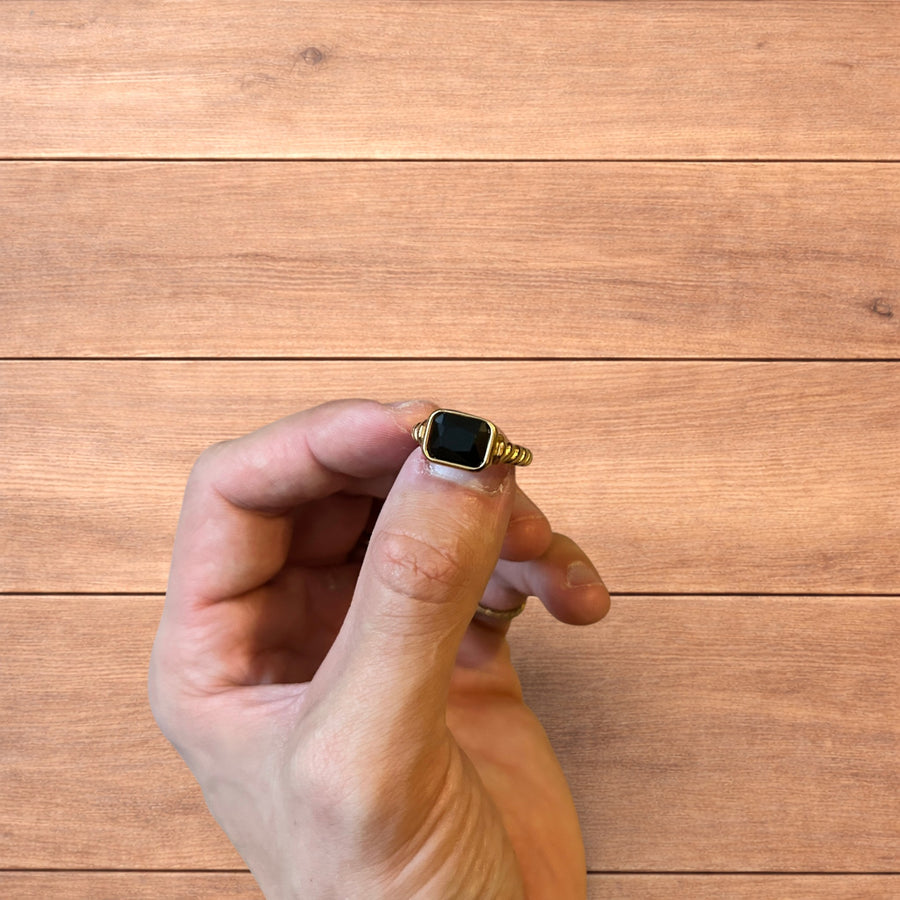 Vintage style gold ring with rectangular black gemstone on gold twisted band