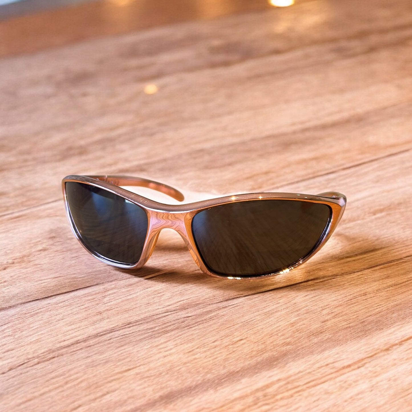 Cool wrap around sunglasses in rose gold frame with black lense. One size.