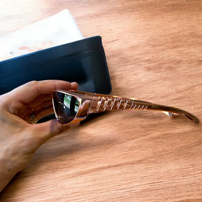 Cool wrap around sunglasses in rose gold frame with black lense. One size.