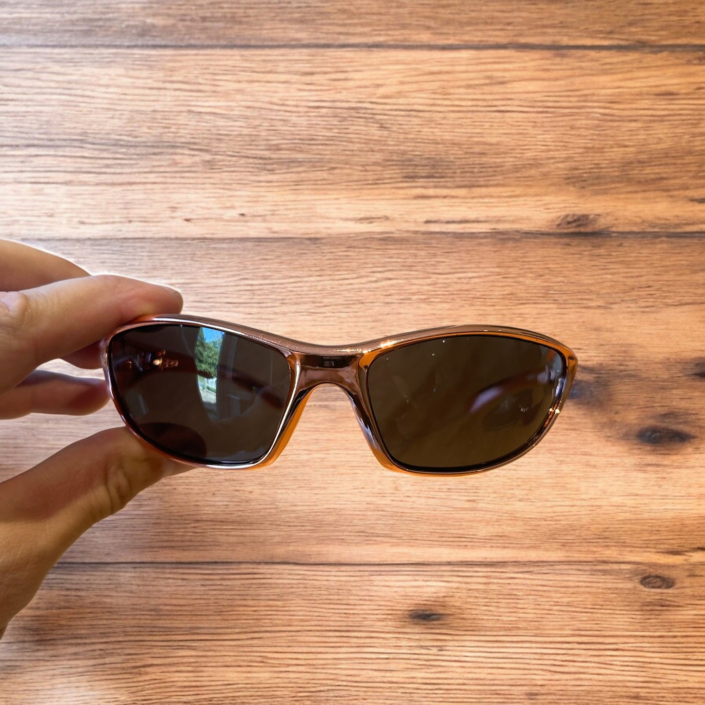 Cool wrap around sunglasses in rose gold frame with black lense. One size.