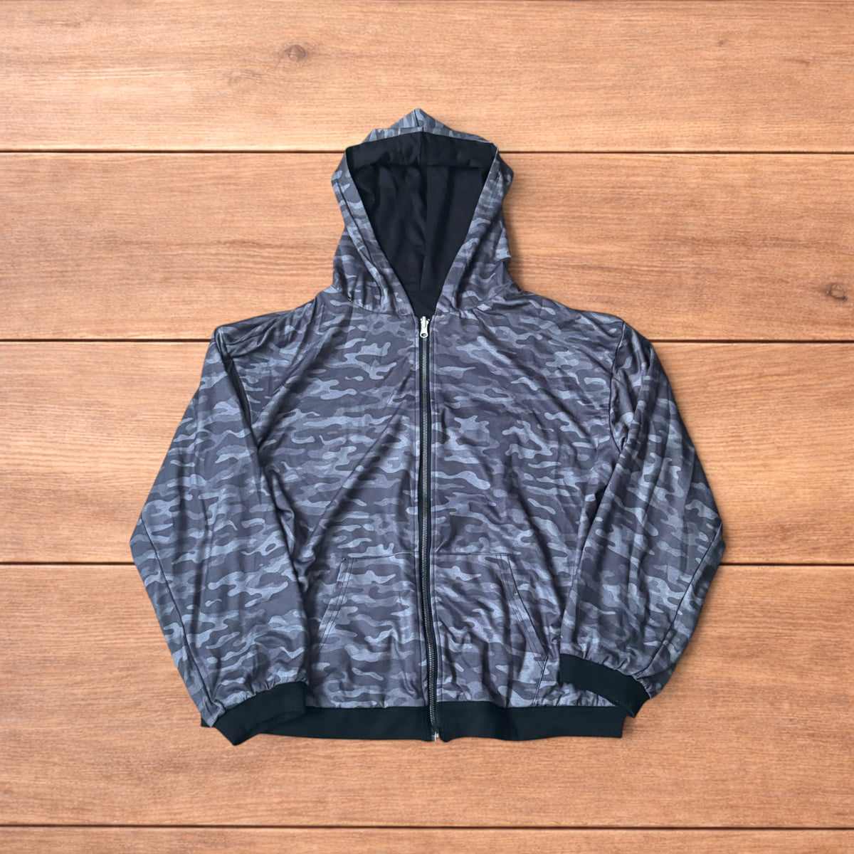 Oversized baggy reversible zip up hoodie jumper laid flat showing grey camo print and black hood lining