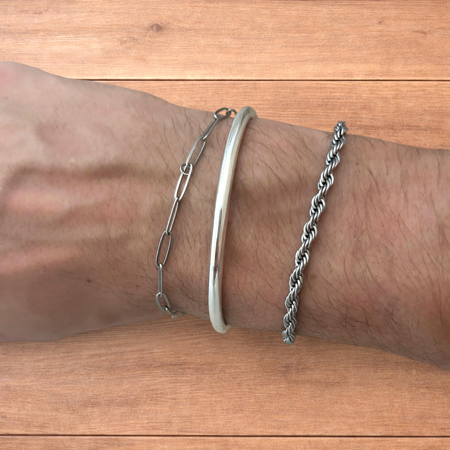 Trio of stainless steel bracelets in silver.