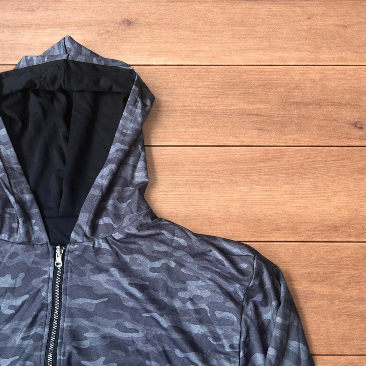 Oversized baggy reversible zip up hoodie jumper laid flat showing grey camo print and black hood lining