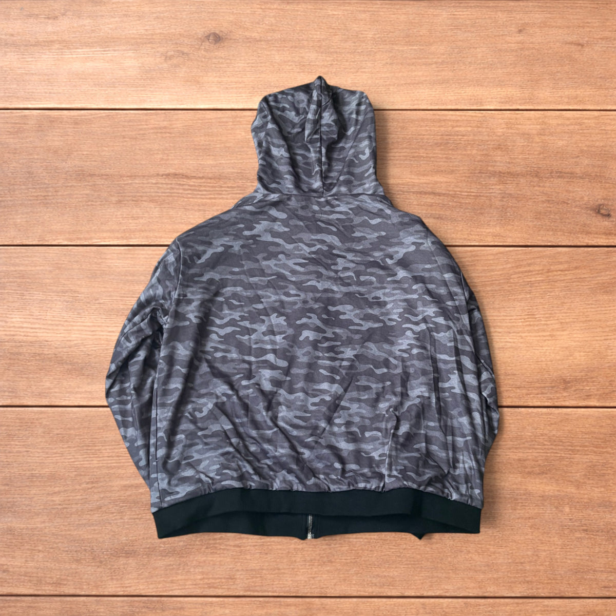 Oversized baggy reversible zip up hoodie jumper laid flat showing grey camo print and black hood lining