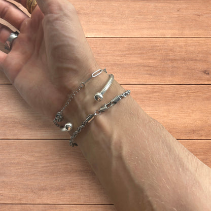 Trio of stainless steel bracelets in silver.