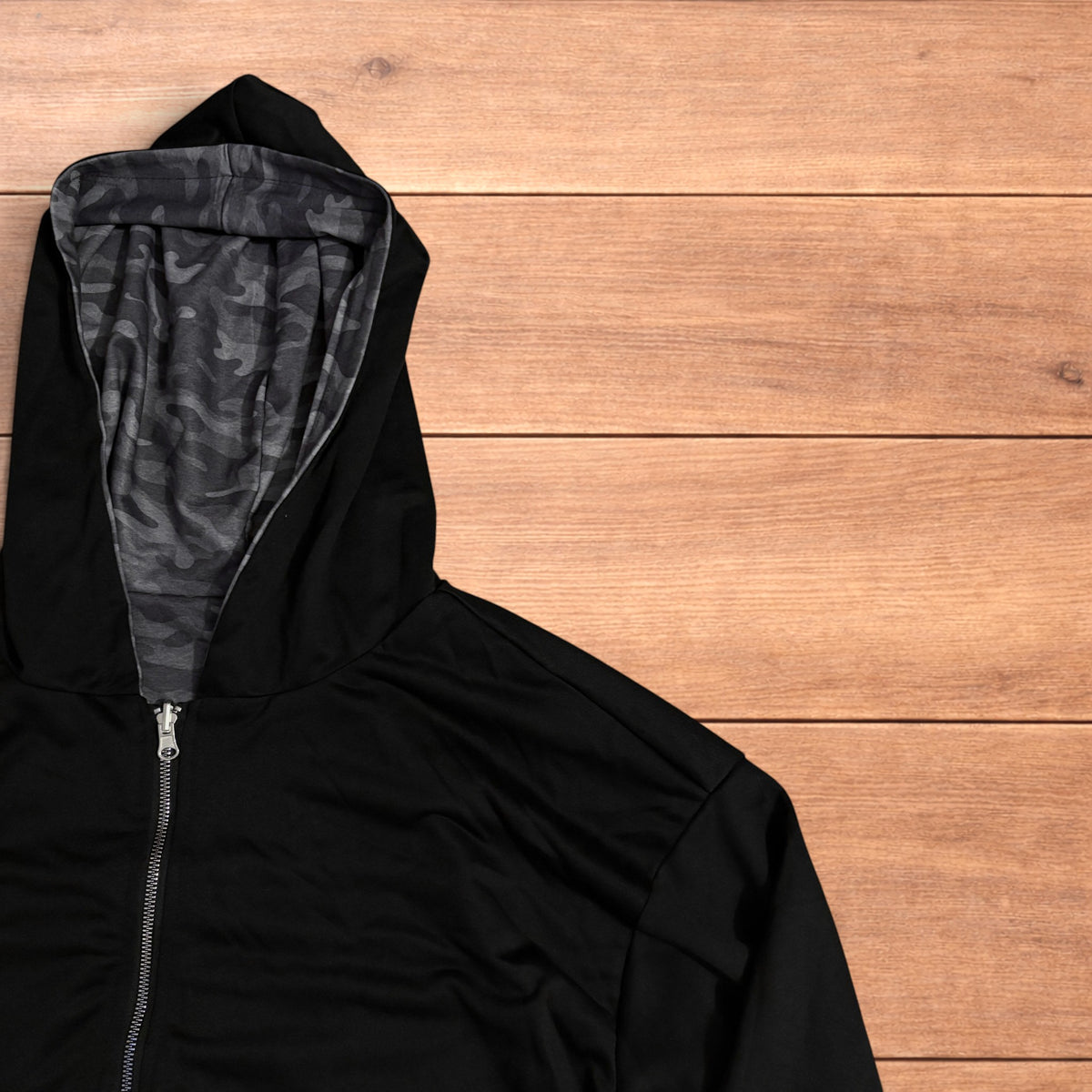 Oversized baggy reversible zip up hoodie jumper laid flat showing grey camo print and black hood lining