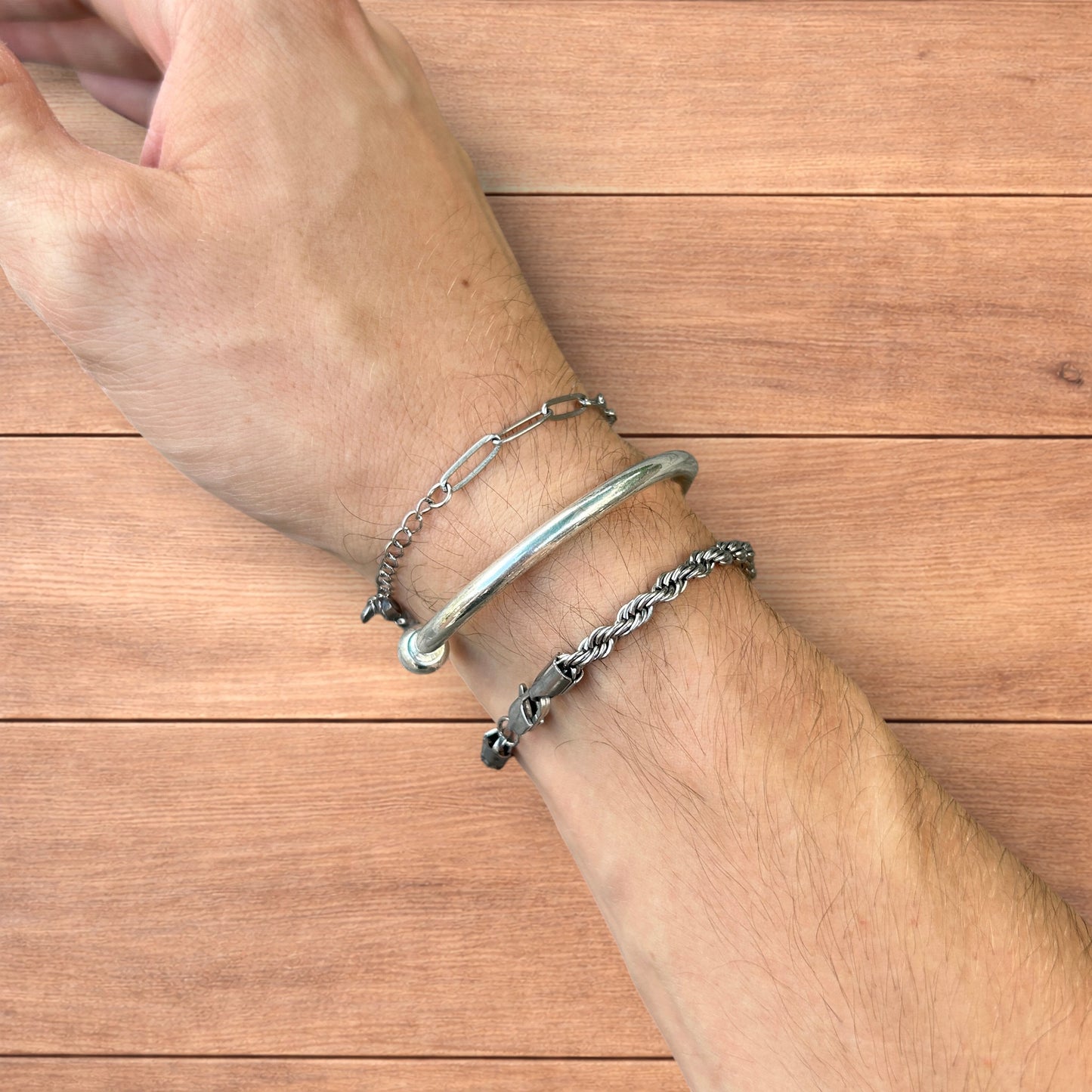 Trio of stainless steel bracelets in silver.