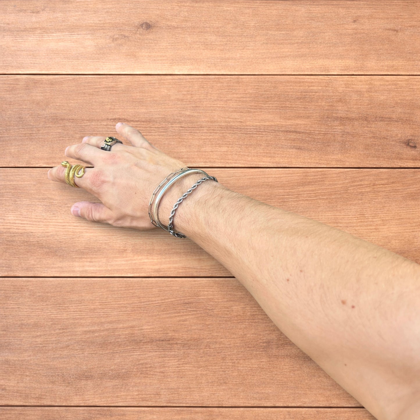 Trio of stainless steel bracelets in silver.