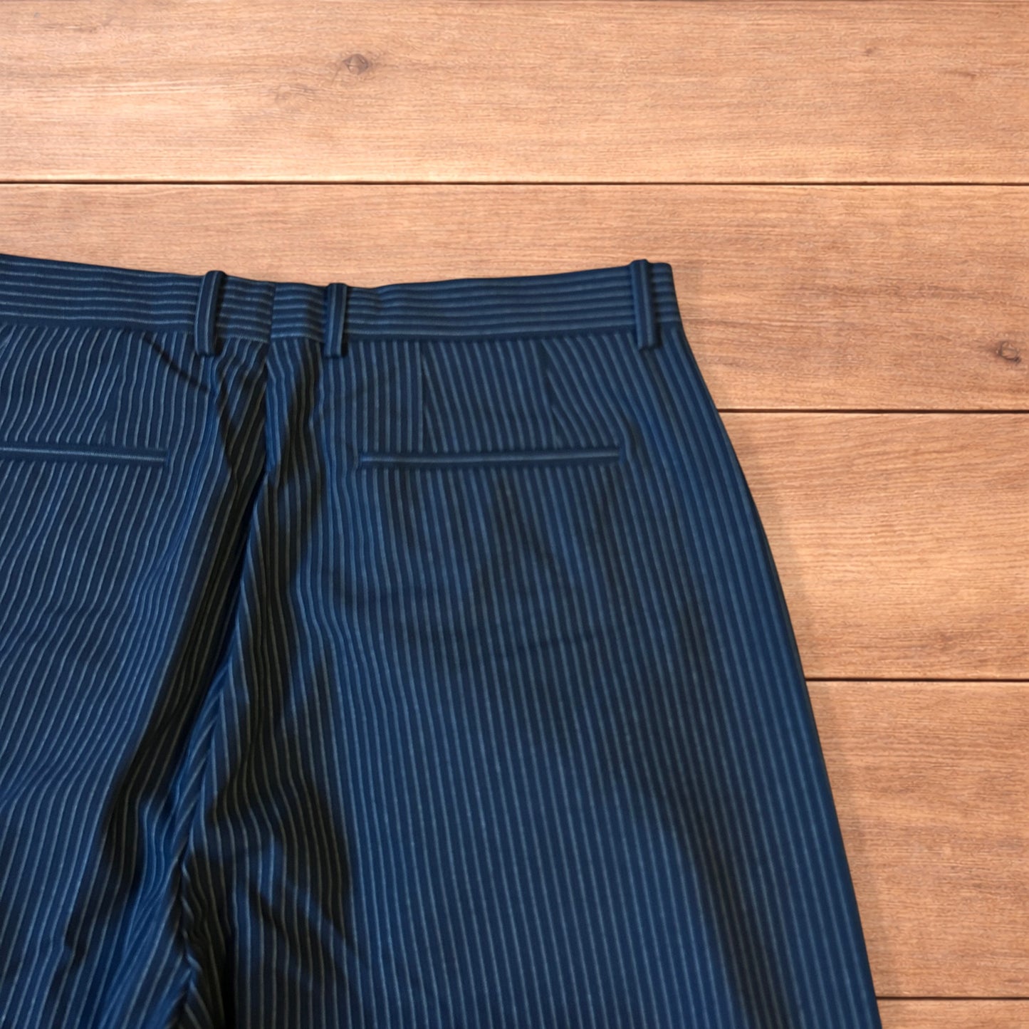 Vintage style baggy wide leg pinstripe tailored trousers in navy blue.