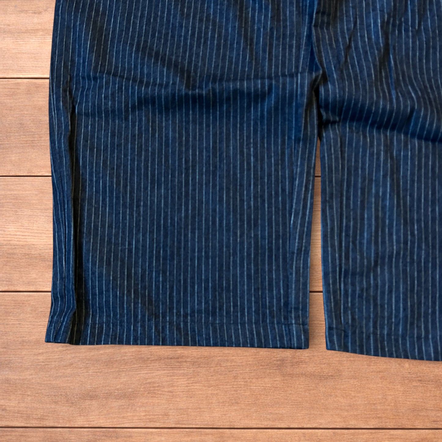 Vintage style baggy wide leg pleated twill pinstripe trousers in navy blue.