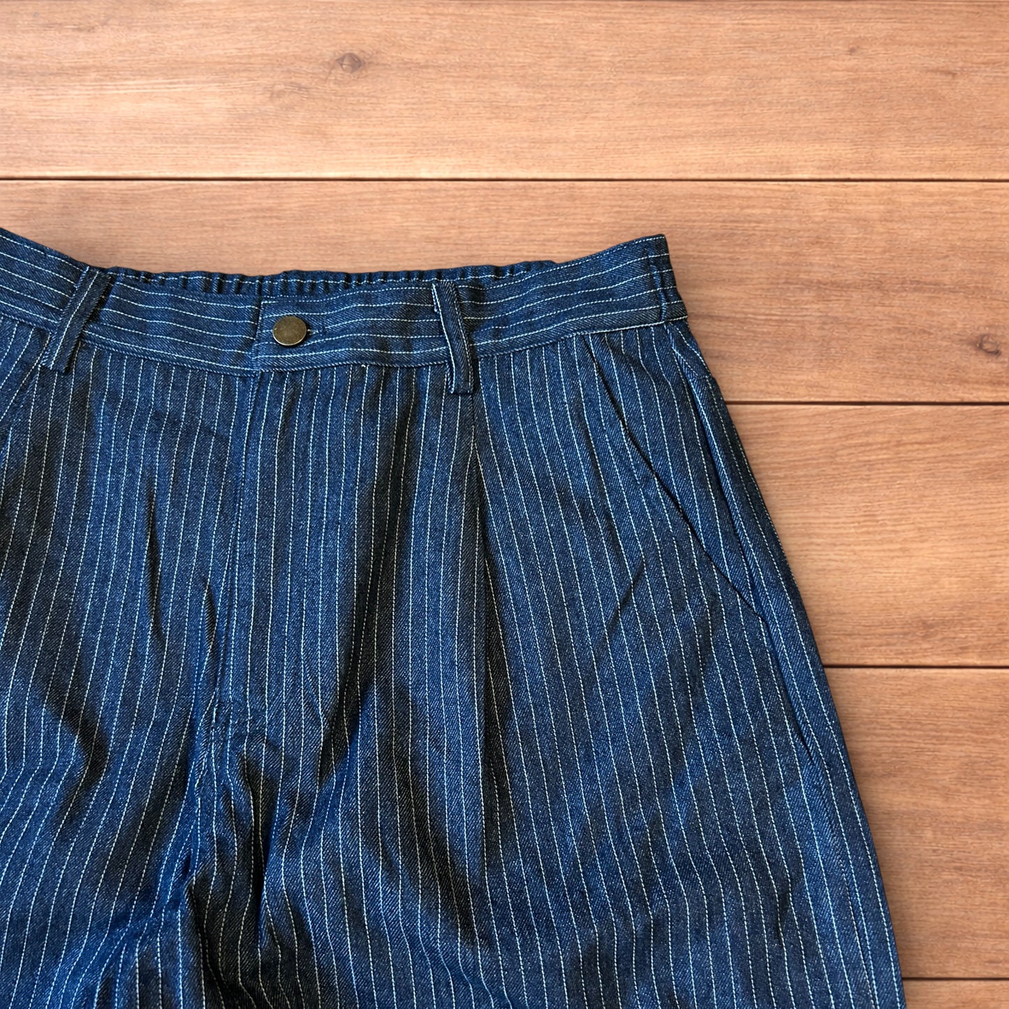 Vintage style baggy wide leg pleated twill pinstripe trousers in navy blue.