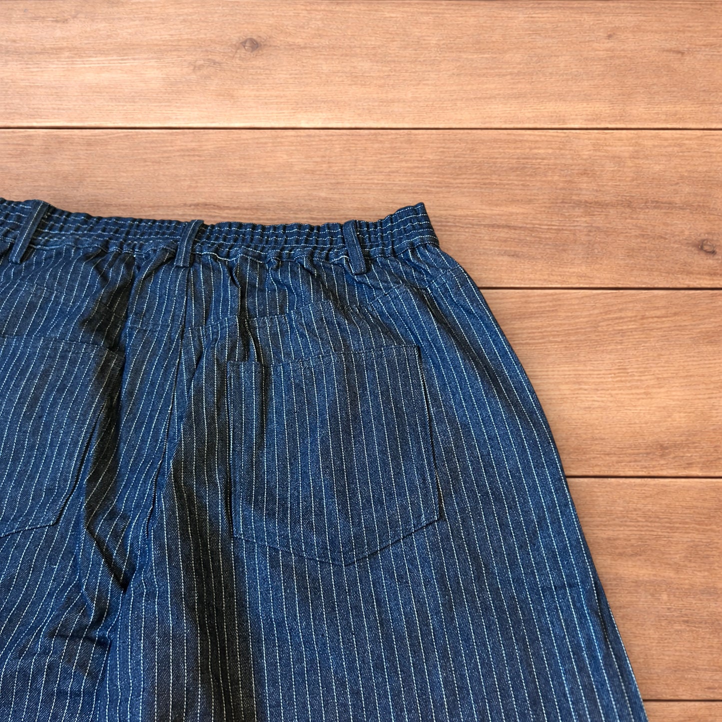 Vintage style baggy wide leg pleated twill pinstripe trousers in navy blue.