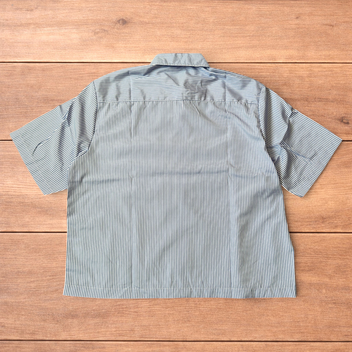 Back view of a blue and white striped lightweight short sleeve shirt