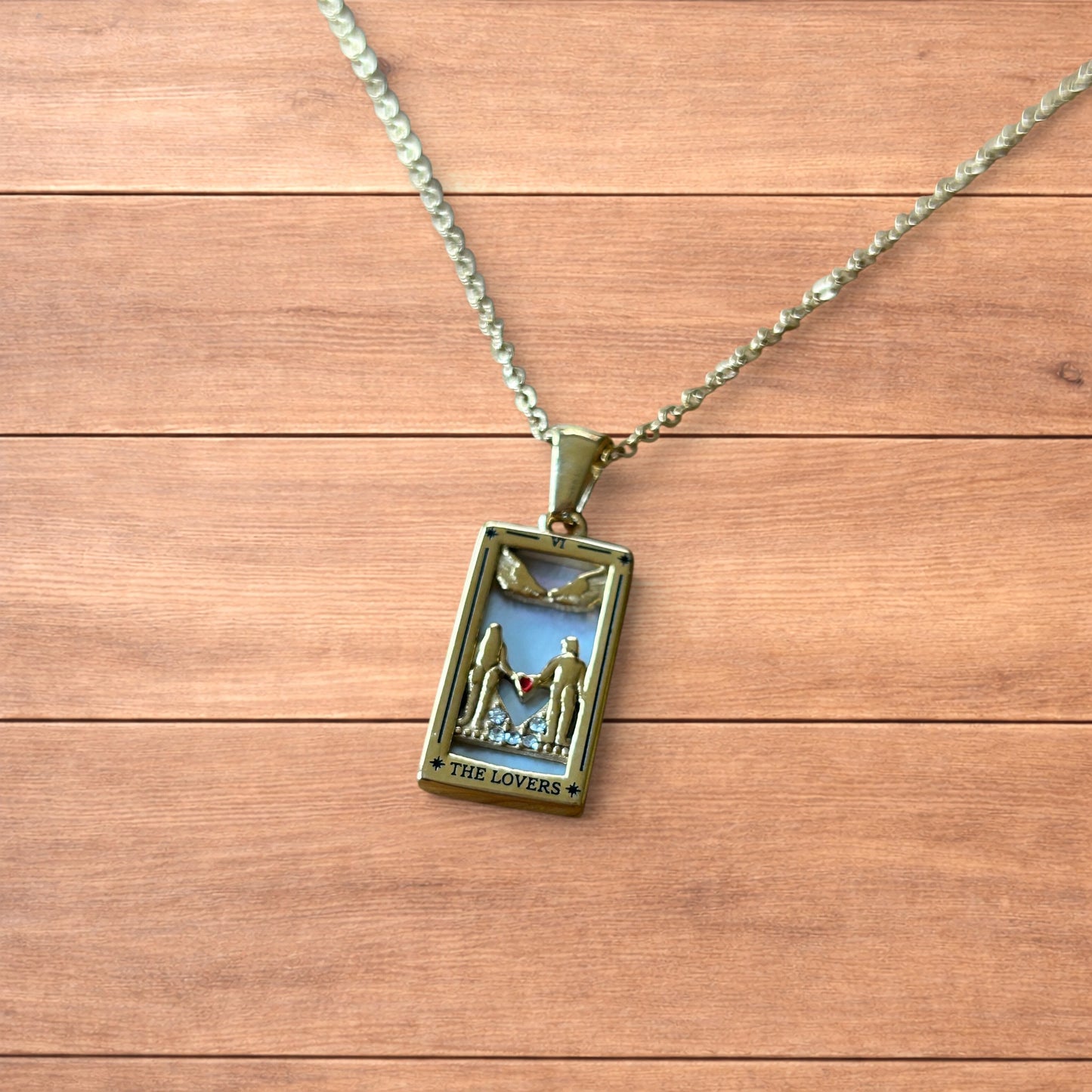 Gold stainless steel pendant necklace with The Lovers tarot card design featuring a couple holding hands and a heart detail.
