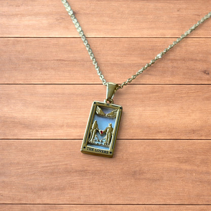 Gold stainless steel pendant necklace with The Lovers tarot card design featuring a couple holding hands and a heart detail.