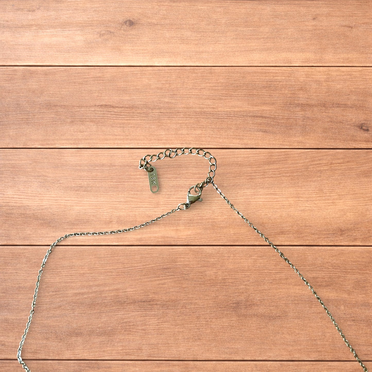 Gold stainless steel pendant necklace with The Lovers tarot card design featuring a couple holding hands and a heart detail.