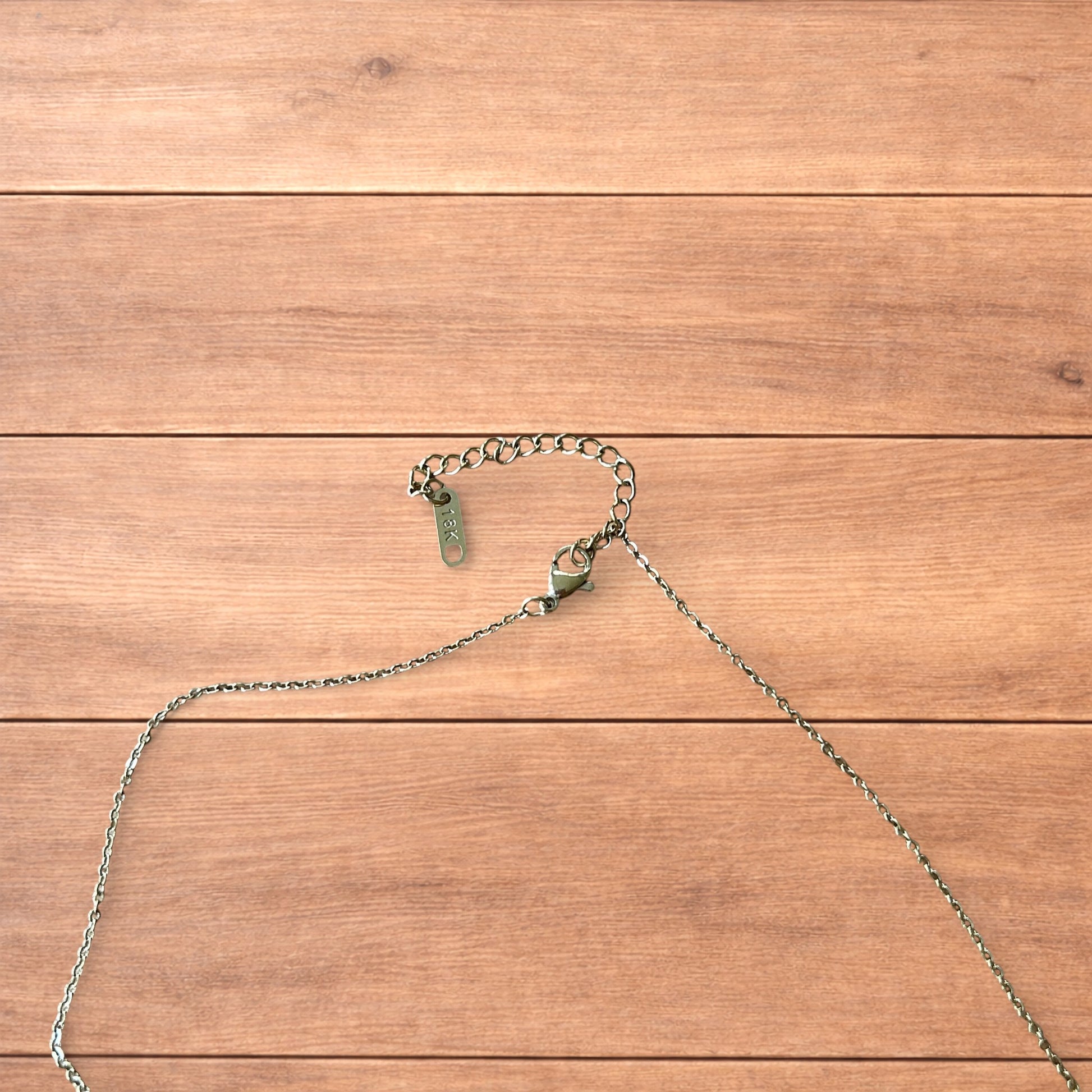 Gold stainless steel pendant necklace with The Lovers tarot card design featuring a couple holding hands and a heart detail.