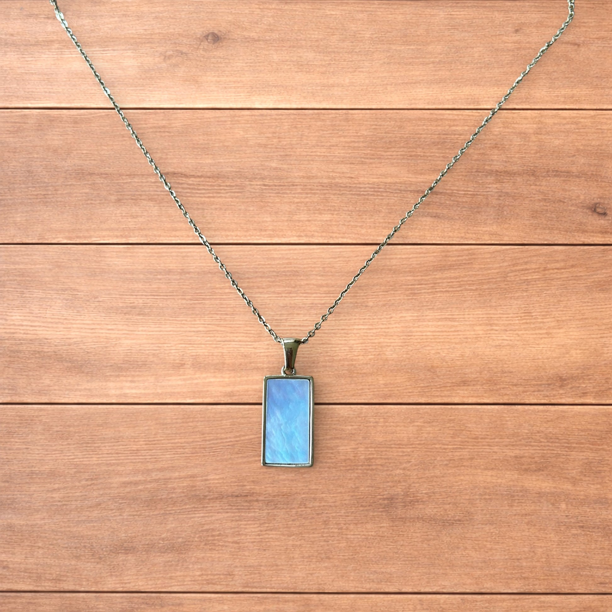 Gold stainless steel pendant necklace with The Lovers tarot card design featuring a couple holding hands and a heart detail.