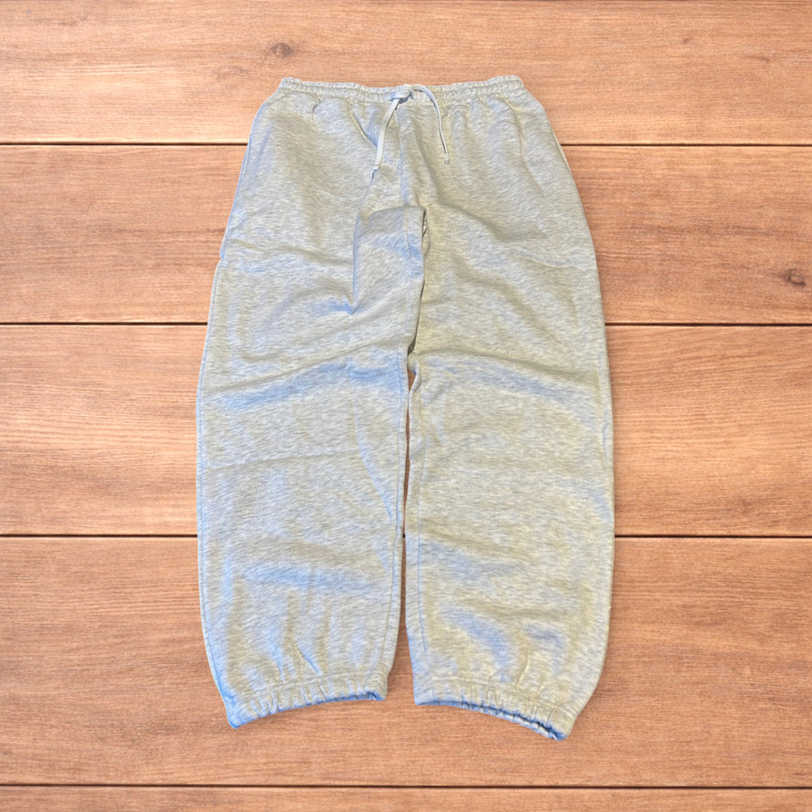 Marl grey baggy wide leg Korean joggers laid flat on wooden surface showing front, back and close-up details.