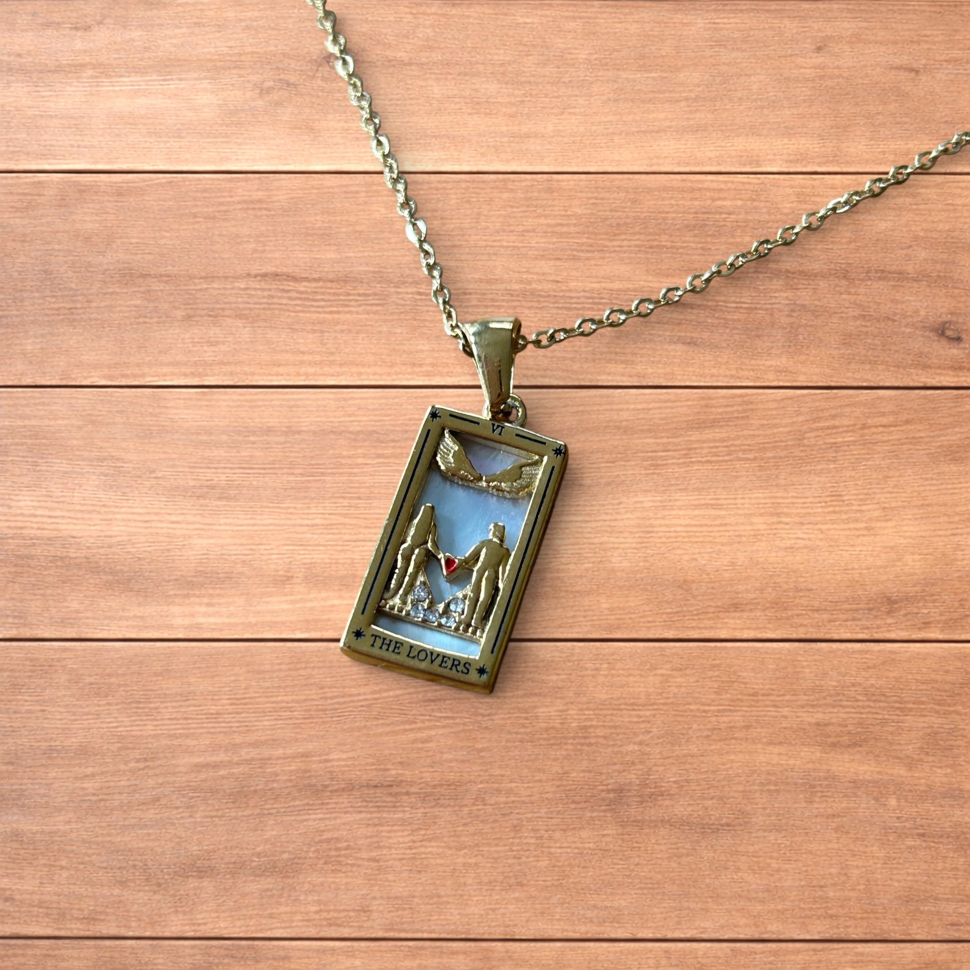 Gold stainless steel pendant necklace with The Lovers tarot card design featuring a couple holding hands and a heart detail.