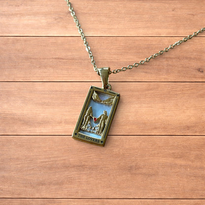 Gold stainless steel pendant necklace with The Lovers tarot card design featuring a couple holding hands and a heart detail.