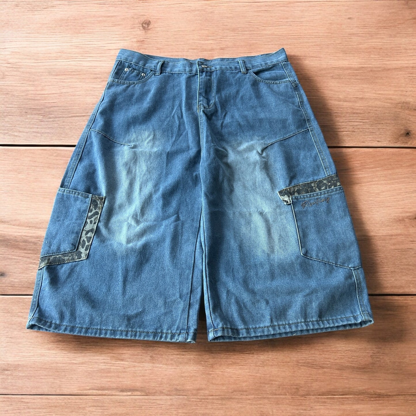 Vintage style baggy wide leg skater fit jorts shorts with leopard print in mid blue.
